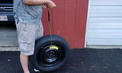 Image of John Goreham weighing a spare tire
